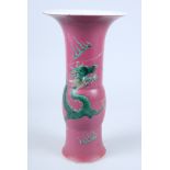 A late 17th century / early 18th century Chinese porcelain gu vase, decorated with flying dragon