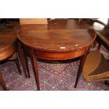 A George III mahogany and kingwood banded semicircular fold-over top card table, on square taper