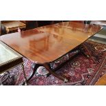 A 19th century mahogany double pedestal dining table with two extra leaves, on turned columns and