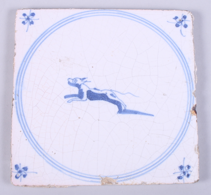 A 19th century tin-glaze earthenware tile, decorated with a leaping dog, 5 1/4" square