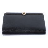 A vintage black lizard skin clutch bag, by Gucci