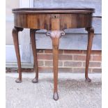 A Georgian walnut semicircular fold-over top tea table with double action top, on cabriole