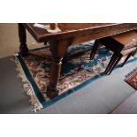 A Chinese contour pile rug with floral figured design on a turquoise ground, 74" x 26" approx