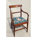 An early 19th century mahogany bar back elbow chair, on square taper and stretchered supports