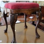 A marquetry stool of early 18th century design with shaped drop-in seat, on cabriole claw and ball