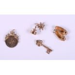 Four 9ct gold charms, a pair of ballet shoes, Cupid, a spinning pendant and a key, 12g