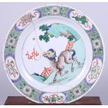 A Chinese famille verte plate with mythical beasts decoration, 10 1/2" dia (heavily restored)