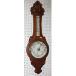 A mid 20th century oak cased aneroid banjo barometer / thermometer with carved scroll decoration,