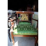 A set of eight mahogany dining chairs with carved giltwood swan shaped back panels, upholstered in a