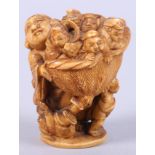 A Meiji period carved ivory okimono, in the form of Hotei carrying a basket of children, signed to