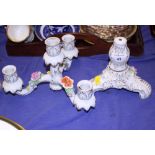 A Continental porcelain three-branch candlestick with floral relief decoration, 12" high