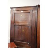 A Georgian oak corner hanging cupboard enclosed panel door, 27" wide