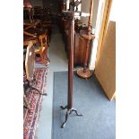 A mahogany torchere with fluted column, on tripod base, 10" dia (damages)