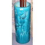 An early 20th century Bretby pottery turquoise glazed cylindrical stick stand with flying dragon