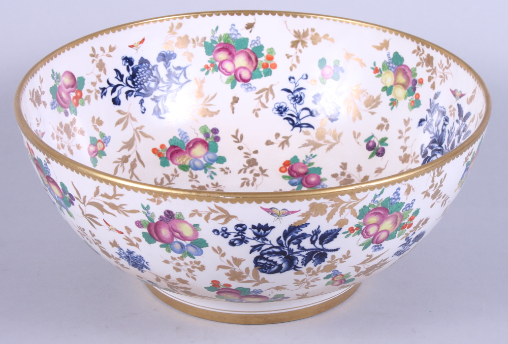 An early 20th century, possibly Booths, porcelain bowl, decorated with flowers and fruit, on a