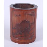 A Chinese carved bamboo cylindrical brush pot, carved with mother oxen and stot, the reverse with