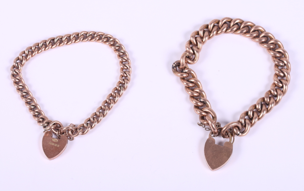 Two 9ct gold curb link bracelets with heart-shaped clasps, 31.8g gross