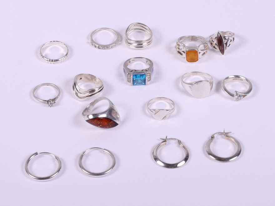 Twelve silver dress rings and two pairs of silver hoop earrings