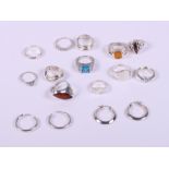 Twelve silver dress rings and two pairs of silver hoop earrings