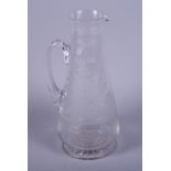 An early 20th century clear glass tapered jug, etched with deer amongst trees within a Greek key and