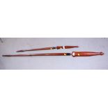 Two Oriental hardwood spears with sheaths, 47" and 76" long