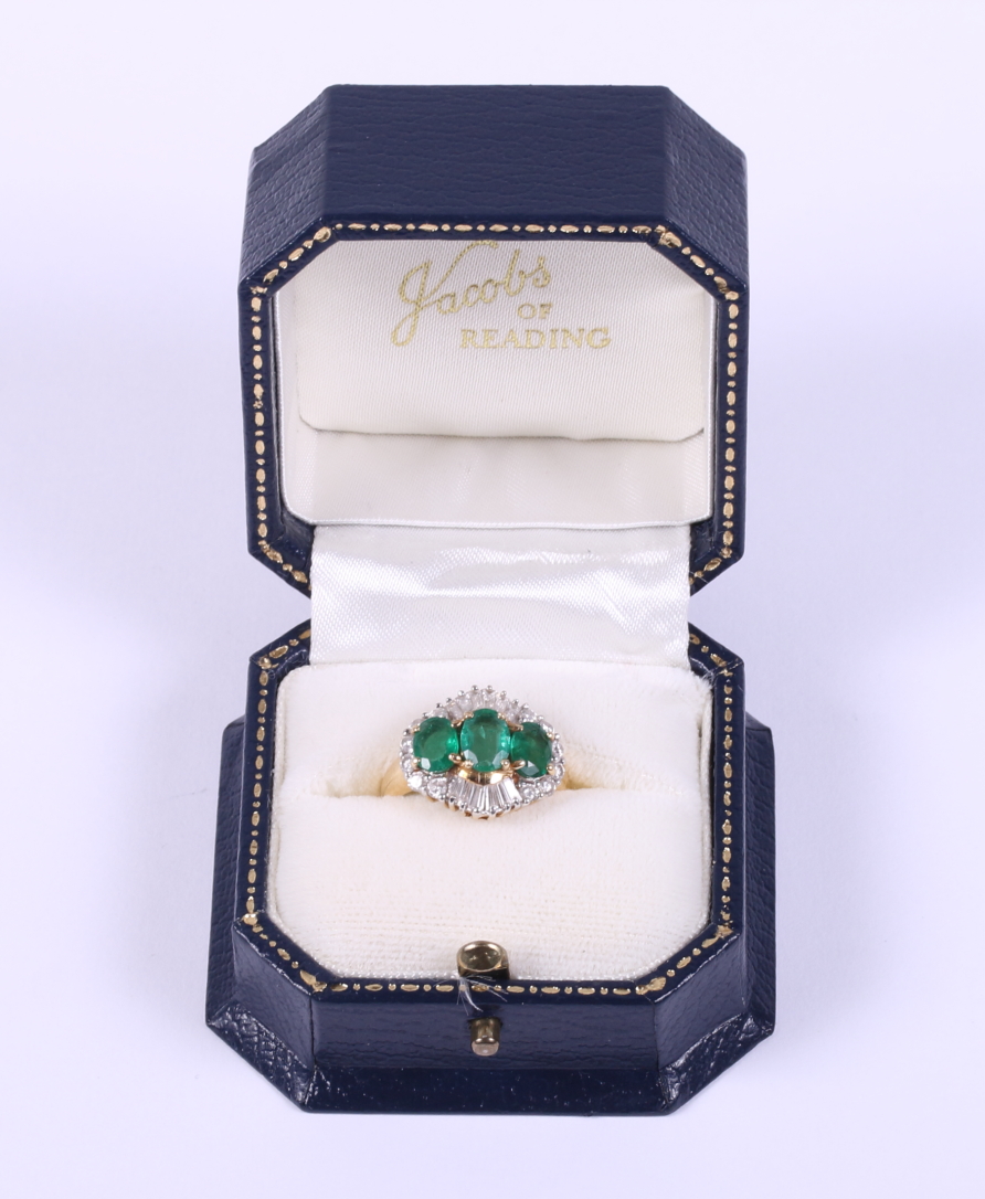 An 18ct gold ring set three graduated emeralds flanked baguette and brilliant cut diamonds, ring - Image 5 of 5