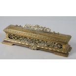 A late 19th century brass ink box with pierced floral and swag decoration, the interior with