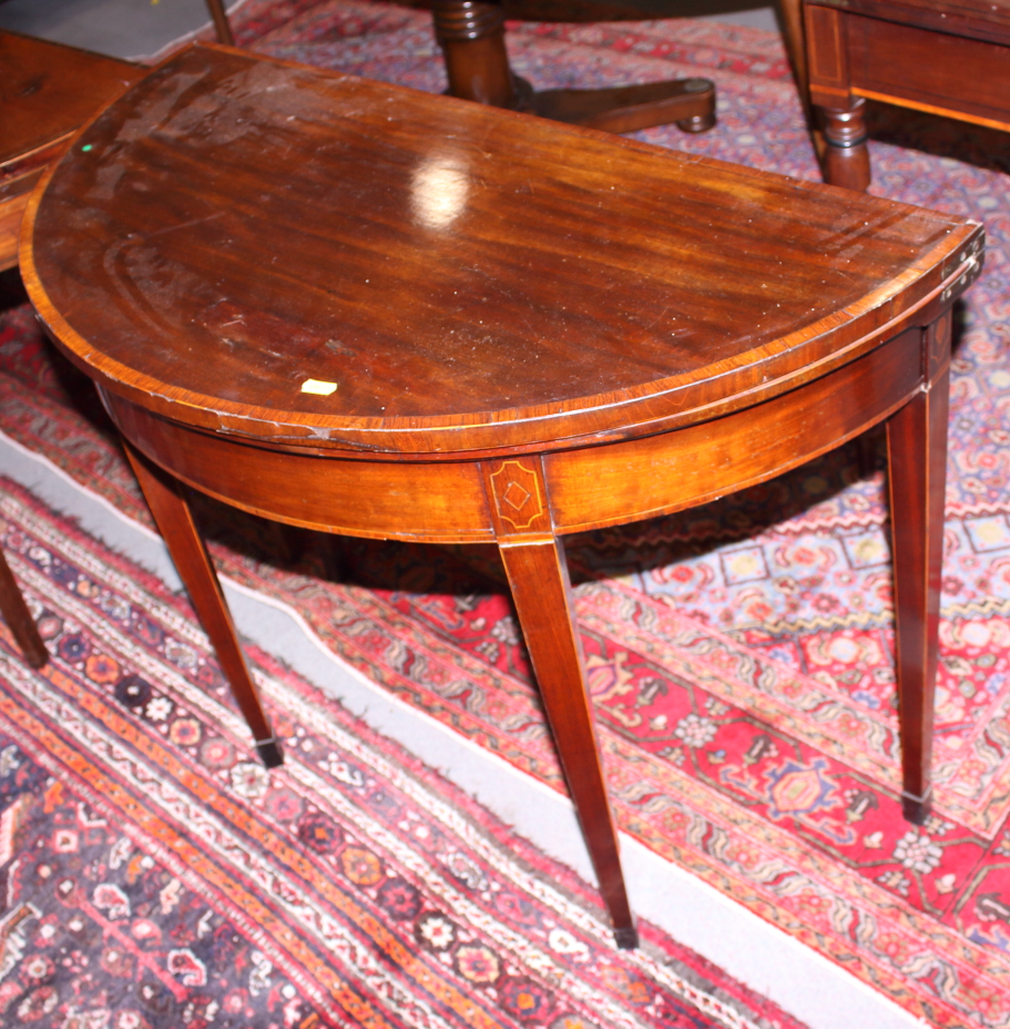 An early 19th century mahogany, satinwood, box and ebony line inlaid fold-over top card table, on