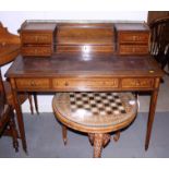 A late 19th century rosewood and inlaid writing desk with brass gallery over central stationery