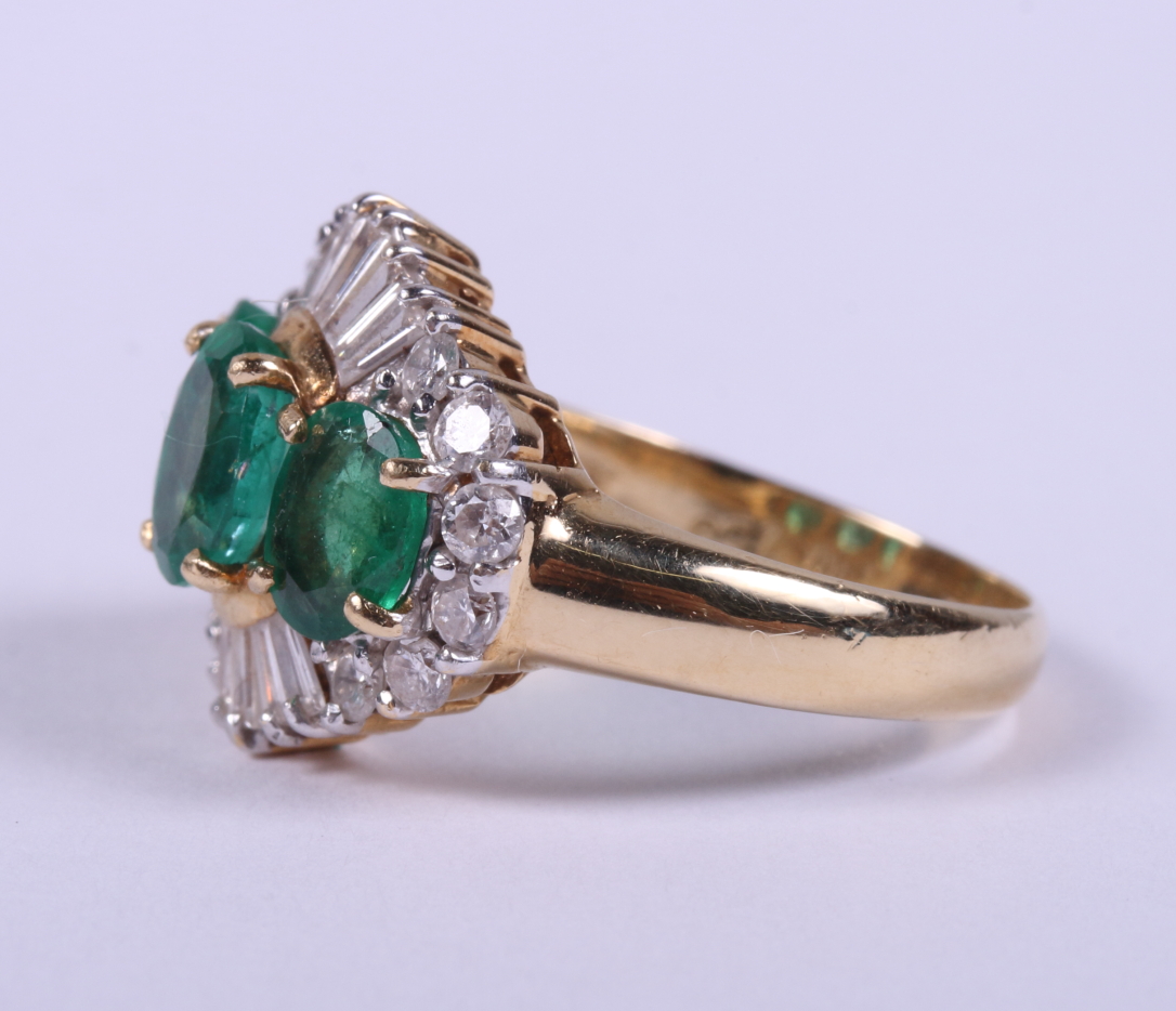 An 18ct gold ring set three graduated emeralds flanked baguette and brilliant cut diamonds, ring - Image 2 of 5