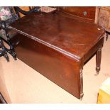 An early 19th century mahogany three-section extending dining table, on reeded turned supports,