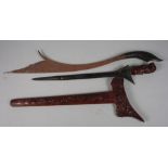 An Indonesian shaped bladed parang with horn handle, 28" long, and an Indonesian kris with