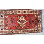 A modern Turkmen rug with star design on a cream ground, 70" x 38" approx
