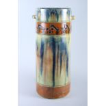 An early 20th century Art pottery cylindrical stick stand with two lug handles and drip glaze