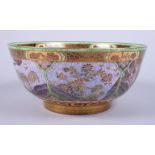 A Wedgwood lustre circular bowl, decorated with Chinese style landscapes, on gold painted