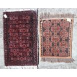 Two tribal mats (one with moth damage) and a sheepskin rug