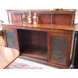A William IV mahogany sideboard with raised back, fitted shelf over cupboards enclosed brass wire