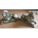 A pair of cast stone recumbent lions, 24" long