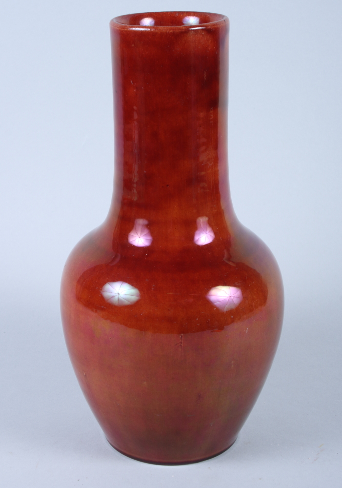 A Chinese sang de boeuf pottery bottle vase with lustre finish, on circular glazed foot, 12" high