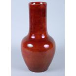 A Chinese sang de boeuf pottery bottle vase with lustre finish, on circular glazed foot, 12" high