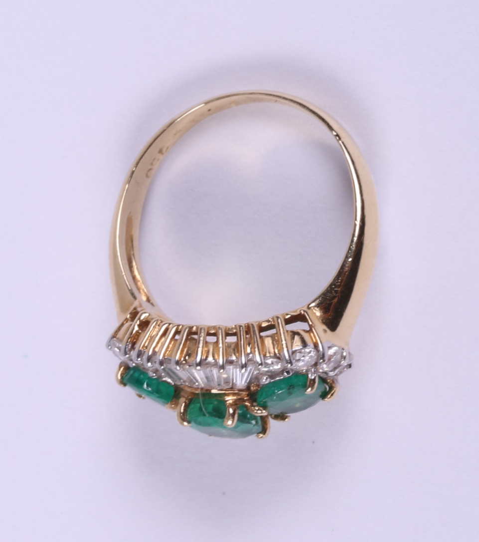 An 18ct gold ring set three graduated emeralds flanked baguette and brilliant cut diamonds, ring - Image 4 of 5