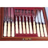 A set of eighteen early 19th century silver plated dessert knives and forks with carved ivory