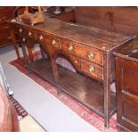 An 18th century oak dresser base, fitted five frieze drawers and pot board, 65" long