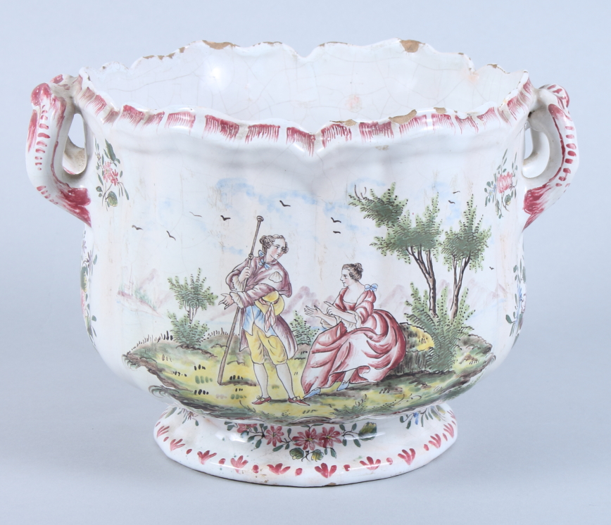 An early 20th century faience two-handled cachepot, with panels of mountains, lakes and figures, 7