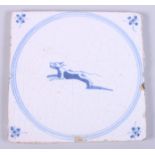 A 19th century tin-glaze earthenware tile, decorated with a leaping dog, 5 1/4" square