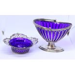 A silver wirework bonbon basket, on oval stand with blue glass liner, 9.9oz troy approx, and one