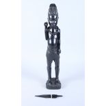 An African carved ebony figure with spear, 23" high (damages)