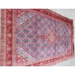 A Herati rug with central medallion on a blue figured ground and red borders, 116" x 76" approx