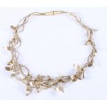 A white metal modernist necklace of cascading leaf design