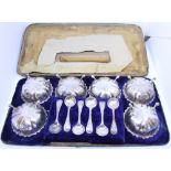 A set of six silver plated salts and spoons, in part fitted case